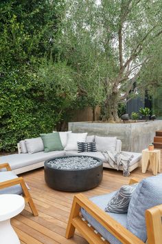 an outdoor living area with furniture and trees