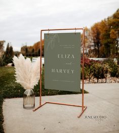 a sign that says elizabeth and harvey on it next to a vase with some flowers in it