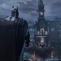 the dark knight is standing in front of an old building with a clock tower on it