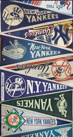 several new york yankees pennants are stacked on top of each other