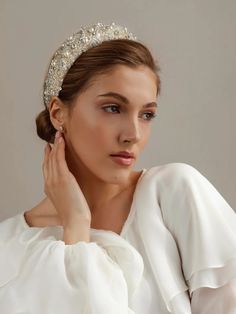 a woman wearing a white dress and a tiara