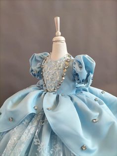 a dress made out of blue satin and pearls