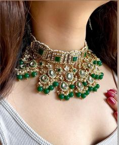 Adorn yourself in timeless elegance with this exquisite emerald green Kundan necklace set, perfect for weddings and special occasions. Crafted with meticulous attention to detail, the set features vibrant hot pink  hues reminiscent of Pakistani and Punjabi traditions, with a touch of Bollywood glamour. Complete with matching earrings and a stunning maangtika, this Indian Kundan ensemble effortlessly captures the essence of sophistication and grace. Measurements:  Weight- 140 gms  Necklace Length Heavy Green Jewelry For Eid, Green Kundan Necklace For Eid Wedding, Emerald Meenakari Kundan Necklace For Wedding, Heavy Green Kundan Necklace For Eid, Green Jewelry For Wedding On Eid, Green Jewelry For Wedding And Eid, Heavy Green Bridal Necklace For Eid, Green Chandbali Bridal Necklace For Eid, Green Kundan Choker For Wedding