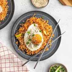 two plates filled with rice and fried eggs