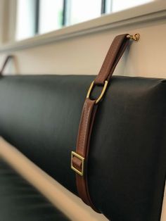 a black and brown bag hanging on the side of a wall