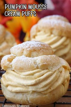 pumpkin mousse cream puffs on a cooling rack