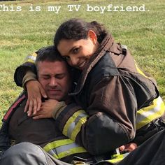 a fireman hugging his friend on the grass with a message above him that reads, this is my tv boyfriend