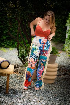 Look like paradise with our ISLAND GAL | FRINGE PANTS. Featuring a tropical print with fringe accents, these super sexy pants will make a bold statement with their vibrant colors and eye-catching prints. Embrace your inner island goddess and turn heads wherever you go! DETAILS & FIT Non-stretch pants High-waisted Elastic waistband Pockets Flared Cuffed ankles CONTENTS & CARE Inseam is 30 inches 90% Polyester 10% Spandex Hand wash cold Do Not Dry Bohemian Bottoms With Vibrant Print For Vacation, Vibrant Print Pants For Vacation, Bohemian Vibrant Print Vacation Bottoms, Bohemian Tropical Print Bottoms For Spring, Bohemian Bottoms With Tropical Print For Spring, Multicolor Tropical Print Summer Pants, Vibrant Print Beach Bottoms For Vacation, Vibrant Print Bottoms For Vacation Beach Season, Vibrant Print Bottoms For Beach Vacation