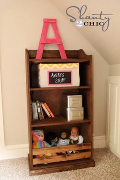 a book shelf with books and toys on it in a child's playroom