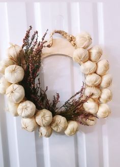 a wreath made out of garlic is hanging on the wall