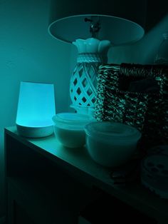 a table topped with bowls next to a lamp