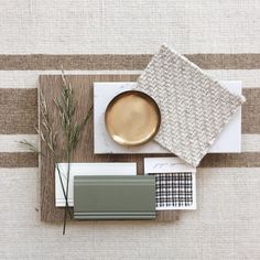 a place setting with a gold plate, napkins and other items