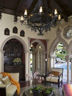 a living room filled with furniture and a chandelier