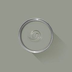 an empty tin can sitting on top of a white surface with a shadow from the lid