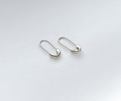 These earrings can be worn as a single earring or as a pair. They have the 925 sterling silver stamp on one side of the safety pin's head. These earrings are light pieces and hook comfortably through the ear. M A T E R I A L Hypoallergenic High-Quality Solid 925 Sterling Silver ( 18K Gold Plated / White Gold Plated) S I Z E Approx. Length 0.75 in / 19mm Minimalist Sterling Silver Clip-on Jewelry, Sterling Silver Clip-on Earrings For Everyday, Sterling Silver Clip-on Earrings Set For Everyday, Minimalist Safety Pin Earrings, Minimalist Silver Clip-on Cartilage Earrings, Safety Pin Shaped Earrings With Ear Wire, Sterling Silver Clip-on Hoop Earrings, Minimalist Sterling Silver Clip-on Hoop Earrings, Safety Pin Earrings As Gift