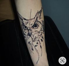 an owl tattoo on the left arm