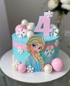 a frozen princess birthday cake with frosting and decorations