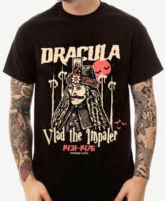 Unleash your inner vampire with the 'Dracula' Unisex Tee! Featuring the iconic figure of Dracula Vlad the Impaler, this spooky t-shirt is perfect for all your Halloween festivities. Embrace your Halloween spirit and stand out from the crowd with this unique and playful tee. (No garlic required. Fangs not included.) . Dracula Vlad the Impaler. 100% combed ringspun cotton· Light fabric· Premium fit· Runs bigger than usual· Original design Care Instructions: Machine wash cold. Do not bleach. Tumble Alternative Style Top For Halloween Costume Party, Gothic Halloween Concert T-shirt, Halloween Crew Neck Tops With Band Logo, Horror Graphic Print Top For Alternative Fashion, Black Horror Tops For Alternative Fashion, Halloween Band Logo T-shirt For Fans, Halloween Band Merch Tops With Band Logo, Halloween Band Merch Top With Band Logo, Halloween Band Logo Tops For Alternative Fashion