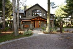 a large house surrounded by trees in the woods