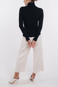 Our classic long sleeve turtleneck is perfect for layering or wearing on it's own. TCVRT00 - 100% superfine cashmere- Rib stitch detail- Fitted- Hits at hip- Model is 5'9" and wearing a size Small Elegant Spring Turtleneck For Layering, Elegant Fine Knit Turtleneck For Spring, Fine Knit Turtleneck For Fall Workwear, Cashmere Long Sleeve Turtleneck For Layering, Elegant Turtleneck Mock Neck Top, Elegant Fine Knit Turtleneck For Layering, Elegant Stretch Fine Knit Turtleneck, Merino Wool Fine Knit Turtleneck For Workwear, Fine Knit Merino Wool Turtleneck For Work