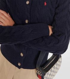 This classic navy cardigan from Polo Ralph Lauren is made from a soft wool and cashmere blend. The cable-knit style features the brand-signature Pony embroidery that imbues every look with preppy charm..Material: 80% wool, 20% cashmere.Care instructions: hand wash.Made in China.Designer color name: Hunter Navy.Closure: buttoned front.True to size.Straight fit.Mid-weight material.Falls to the hip.The model seen in the picture is 178cm-5'10' and wearing a size XS Classic Cable Knit Cardigan For Work, Elegant Navy Winter Cardigan, Classic Navy Cardigan For Fall, Pony Embroidery, Ralph Lauren Womens Clothing, Navy Cardigan, Polo Ralph Lauren Women, Knit Style, Cashmere Cardigan