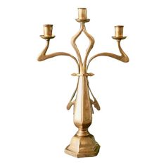 a golden candelabra with three candles on it