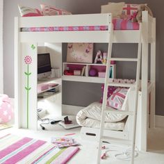 a white bunk bed sitting in a bedroom next to a desk