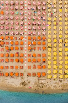 an aerial view of beach chairs and umbrellas