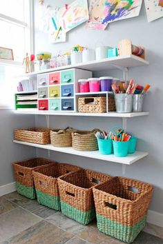 some baskets are lined up on the shelves in this crafting room with white walls