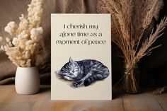 a card that says i cherish my alone line as a moment of peace with a cat sleeping on it