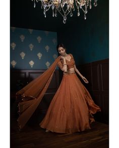 Elegant Orange Sets For Navratri, Orange Georgette Sets For Reception, Elegant Orange Lehenga For Navratri, Elegant Orange Sharara With Sheer Dupatta, Elegant Orange Choli For Festive Occasions, Elegant Orange Choli For Festive Season, Elegant Orange Festive Choli, Elegant Festive Orange Choli, Orange Organza Sharara For Wedding