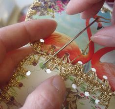 a person is working on a piece of jewelry