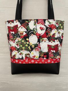 "Christmas Gnomes fabric purse with a black vinyl bottom and ribbon trim. Coordinating inside fabric with 3 pockets and a magnetic snap. 2 matching 27\"  black fabric handles are lined with belting for durability. All Fabric is interfaced for stability Ribbon may vary depending on availability 11.5\"wide. 12\" tall and 3.5\" bottom" Sew Tote Bags, Quilted Tote Bags Patterns, Purses To Sew, Holiday Bags, Christmas Purse, Sew Christmas, Carpet Bags, Purse Covers, Flower Arrangement Designs