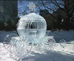 a glass horse drawn carriage sitting in the snow