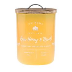 a yellow candle with a wooden lid on a white background in the shape of a canister