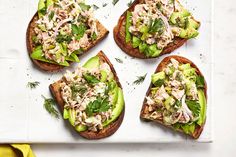 four open faced sandwiches with avocado and tuna