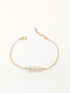 "Our gift to you 10% off your first purchase. Details here - http:/eepurl.com/dpVPBz You have found the perfect dainty pearl bracelet. Available with 1, 2 or 3 pearls. Personalize the number of pearls with your wishes, goals, children etc. Perfect for that special occasion yet simple enough for every day wear. You and your loved one will adore this meaningful gift. DETAILS 14 k fill or Sterling Silver. Choose 1, 2 or 3 pearls. Each fresh water pearl is unique, meaning the size and shape may vary 3 Pearl Bracelet, Pearl Bracelet Jewelry As Gift, Pearl Chain Bracelet As Gift, Elegant Hypoallergenic Name Bracelet With Round Beads, Pearl Drop Bracelet As Gift, Pearl Drop Bangle Bracelet For Gift, Pearl Drop Bracelet Jewelry Gift, Pearl White Bracelets With Pearl Drop As Gift, Pearl White Bracelet With Pearl Drop As Gift