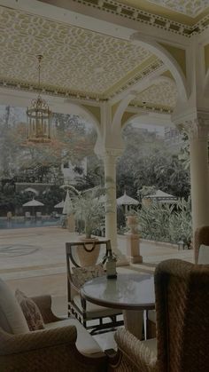 a living room filled with furniture and a chandelier