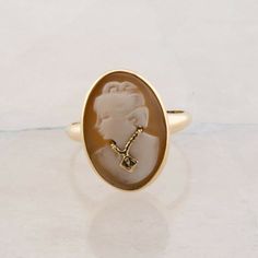 10K Yellow Gold Shell Cameo Ring, woman looking left wearing a necklace, small accent stone to center, Ring size 7, 3.72 gramsStock # BB302R02Most rings are sizable for a small fee. If the ring you are considering is the incorrect size contact us for a quote.This listing contains photographs of the actual item you will receive. Our items are in excellent condition with little or no signs of wear and many are one of a kind pre-owned estate finds. Please look closely at the pictures in this listin Cameo Ring, Woman Looking, Fine Jewelry Designers, Onyx Ring, Yellow Gold Earring, Garnet Rings, Ring Size 7, Earring Backs, Gold Bands