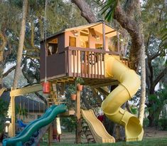 a child's play area with a slide and tree house