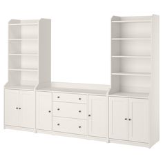 an empty white bookcase with drawers and cupboards