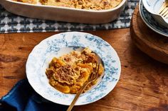 a plate with some food on it next to a casserole dish and fork