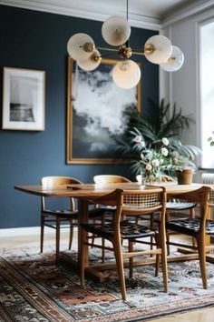 a dining room with blue walls and wooden furniture