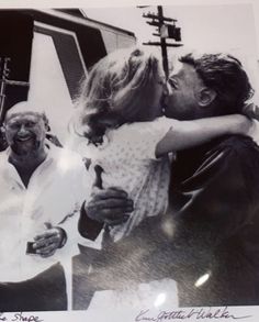 an old black and white photo of two people kissing