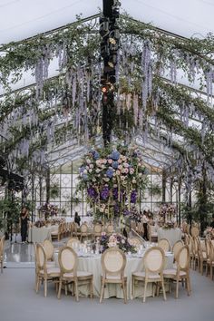 an indoor wedding venue with chandelier and tables