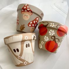 three flower pots with different designs on them