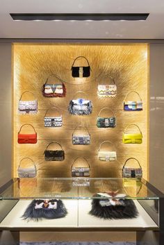 the display case is filled with purses and handbags