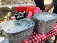 two buckets filled with ice sitting on top of a table