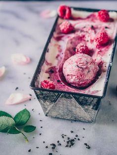 an ice cream dish with raspberries in it