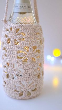 a crocheted wine bottle holder is shown